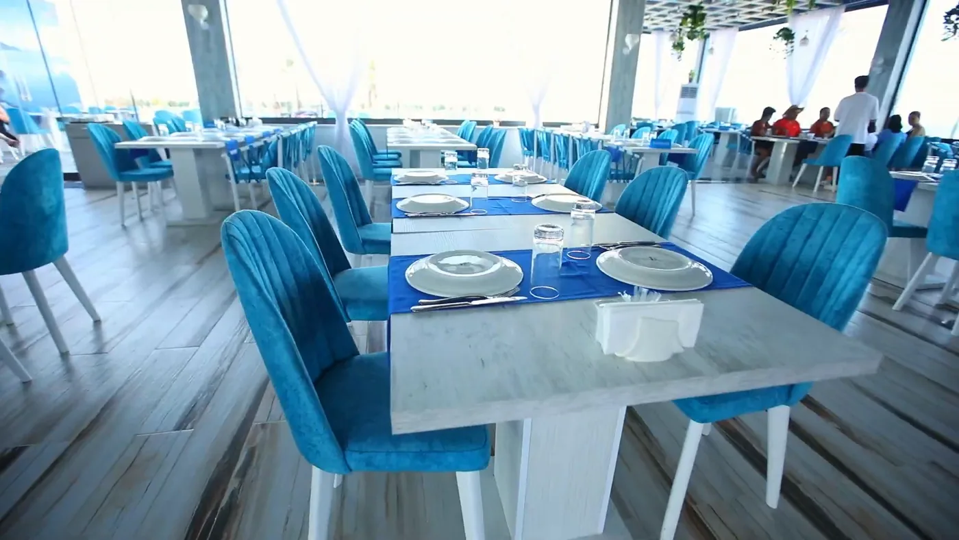 The hall: turquoise chairs and white tables