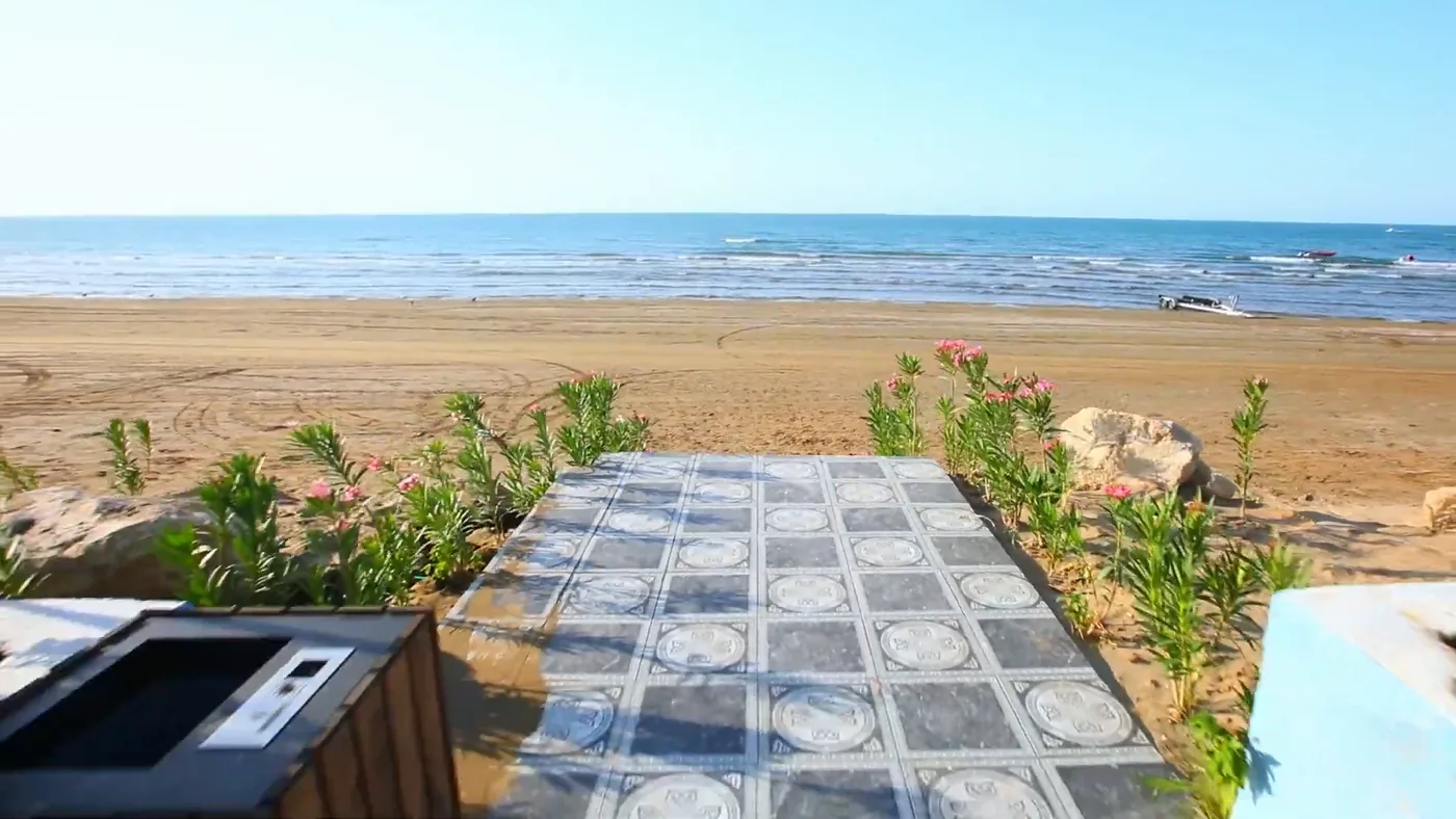 A tiled path from the restaurant to the sea