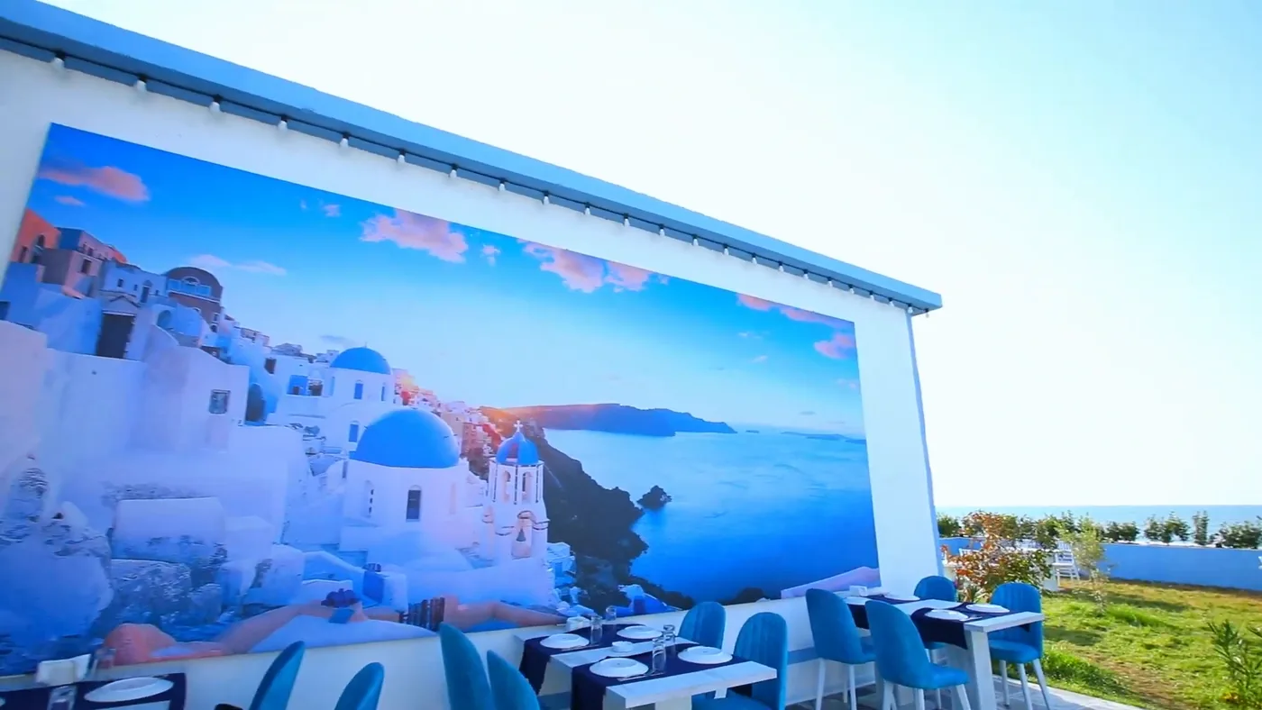 The end wall with a Santorini view above the terrace